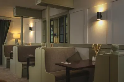 a restaurant with chairs and tables in a room at The Inn For All Seasons in Redruth