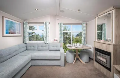 a living room with a couch and a table at Widemouth Bay Caravan Park in Bude