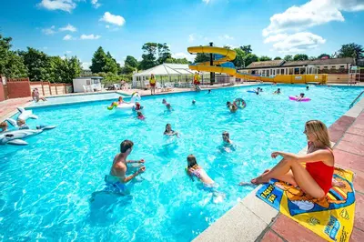 a group of people in a swimming pool at Trelawne Manor Holiday Park in Looe