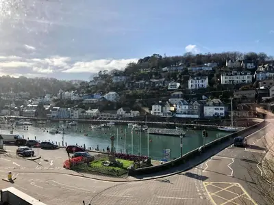 a view of a river with houses and a city at Bridgeside Guest House in Looe