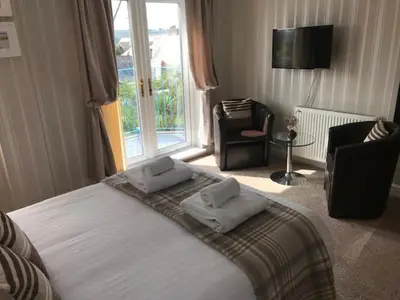a bedroom with a bed with two pillows on it at Cotswold House in Falmouth