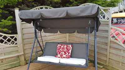a canopy bed with a pillow on a patio at Seaside Apartment in Newquay