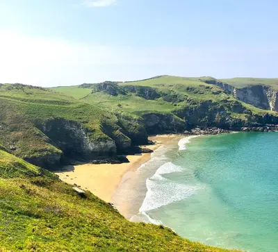 an aerial view of a beach with the ocean at Bosayne Guest House in Tintagel