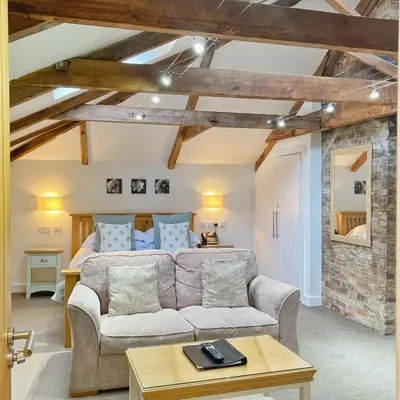 a living room with a couch and a bed at The Britannia Inn and Restaurant in Par