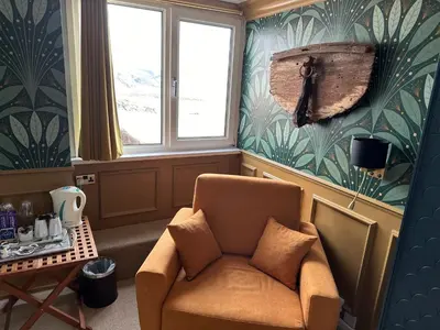 a living room with a chair and a table at The Watermark in Looe