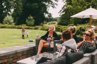 a group of women sitting in chairs in a garden at The Cornwall Hotel Spa & Lodges in St Austell