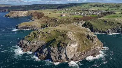 an aerial view of a rocky island in the ocean at Camelot Castle Hotel in Tintagel