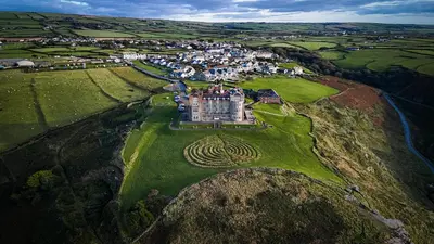 an aerial view of a castle on a hill at Camelot Castle Hotel in Tintagel