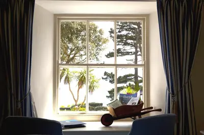 a window with a book cart in front of it at Talland Bay Hotel, Looe in Talland