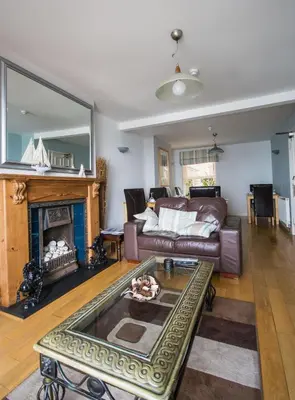 a living room with a couch and a fireplace at Atlantic Heights Guest House in St Ives