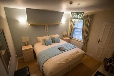 a bedroom with a large bed and a window at Atlantic Heights Guest House in St Ives