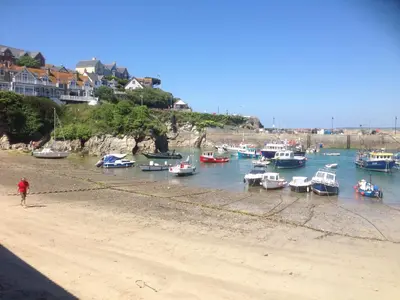 a group of boats are docked on a beach at Fistral Studio in Newquay