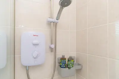 a shower with a shower head in a bathroom at Oystercatcher in St Ives