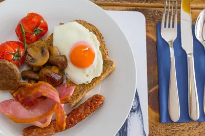 a plate of breakfast food with an egg and sausage at Oystercatcher in St Ives