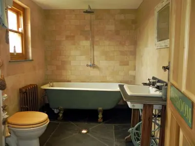 a bathroom with a tub and a toilet and a sink at Neptunes Rest in St Austell