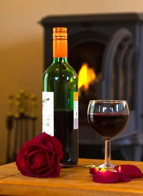 a bottle of wine and a glass on a table at The Old Wagon House in Saint Clether