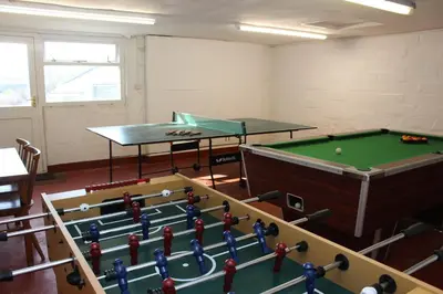 a room with two ping pong tables and a pool table at Almond Tree Cottage in Lanteglos