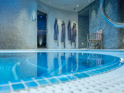 a swimming pool with clothes hanging on a wall at The Headland Hotel and Spa in Newquay