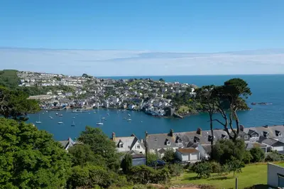 a view of a town with boats in the water at Fowey Hall Hotel in Fowey