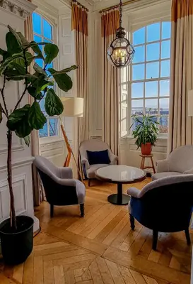 a living room with chairs and a potted plant at Fowey Hall Hotel in Fowey