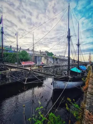 a boat is docked at a dock in the water at Sea Haze Charlestown in St Austell