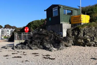 a house on top of a rock on the beach at Sure Hotel Collection by Best Western Porth Veor Manor Hotel in Newquay