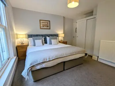 a bedroom with a large bed and a window at The Claremont Hotel-Adult Only in Polperro