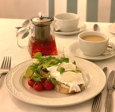 a plate of food on a table with a cup of coffee at The Claremont Hotel-Adult Only in Polperro