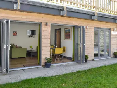 a patio extension with sliding glass doors on a house at Kataluma in Germoe