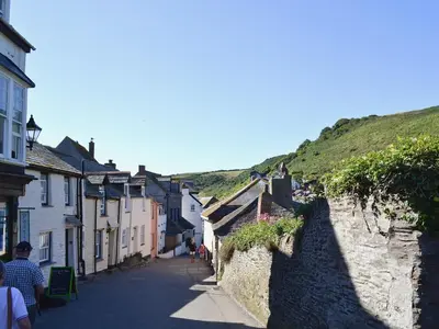 a street in a small town with houses on a hill at Silvershell View in Port Isaac