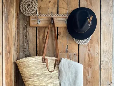 a straw bag and a hat on a wooden wall at Silvershell View in Port Isaac
