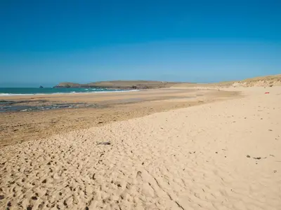 an empty beach with footprints in the sand at Bay Retreat Villas in St Merryn