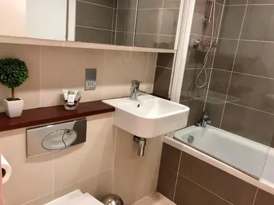 a bathroom with a sink and a toilet at Seaview, Luxury apartment, 2 min walk to Porth Beach in Newquay