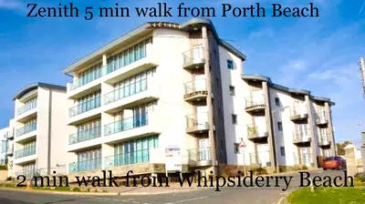 a white building with balconies on the side of it at Seaview, Luxury apartment, 2 min walk to Porth Beach in Newquay