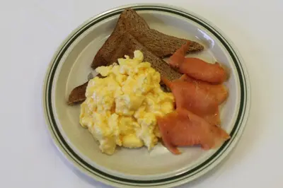a plate of breakfast food with eggs bread and toast at Trevanger Farm Bed and Breakfast in Wadebridge