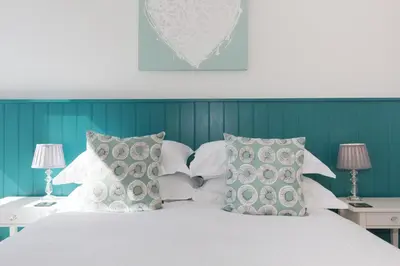 a bedroom with a white bed with pillows at 3 Porthminster B&B in St Ives