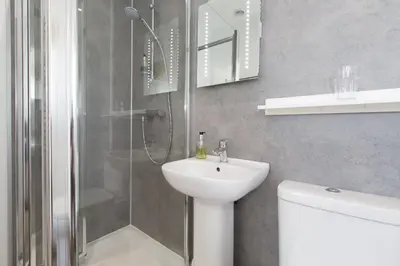 a bathroom with a shower and a sink and a toilet at 3 Porthminster B&B in St Ives