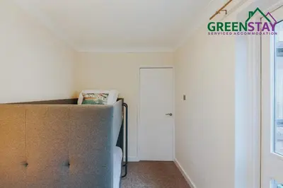 a living room with a couch and a window at 