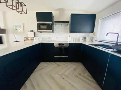 a kitchen with black and white counters and a sink at 