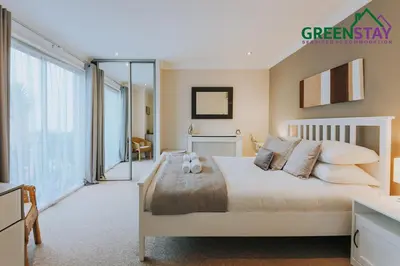 a bedroom with a bed and a large window at 