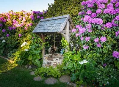 a garden with a bird house and flowers at Rockleigh Place in St Austell