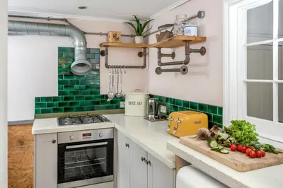 a kitchen with a counter with vegetables on a cutting board at The Bunker House in Newquay