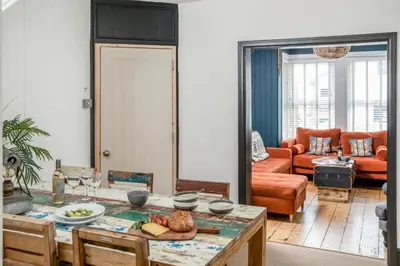 a living room with a table and a couch at The Bunker House in Newquay
