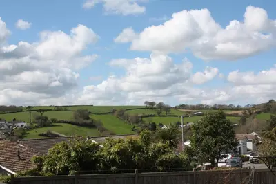 a view of a green field with clouds in the sky at Linton Luxury Holiday Home in Mevagissey