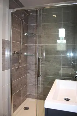 a shower with a glass door next to a sink at Linton Luxury Holiday Home in Mevagissey