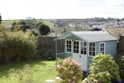 a small blue dog house in a garden at Linton Luxury Holiday Home in Mevagissey