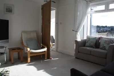 a living room with a couch and a chair at Linton Luxury Holiday Home in Mevagissey