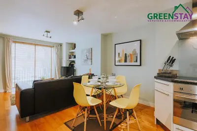a kitchen and living room with a table and chairs at 