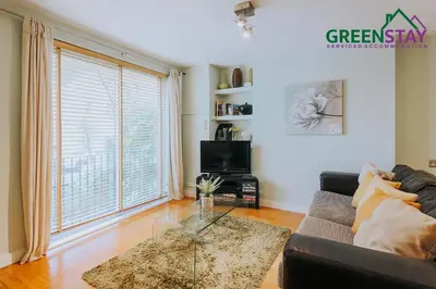 a living room with a couch and a glass table at 