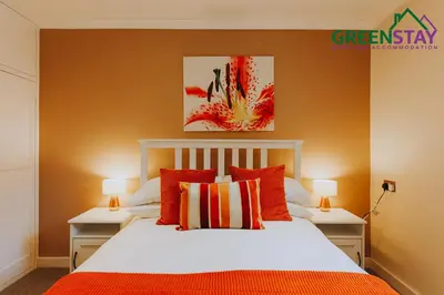 a bedroom with a white bed with red pillows at 